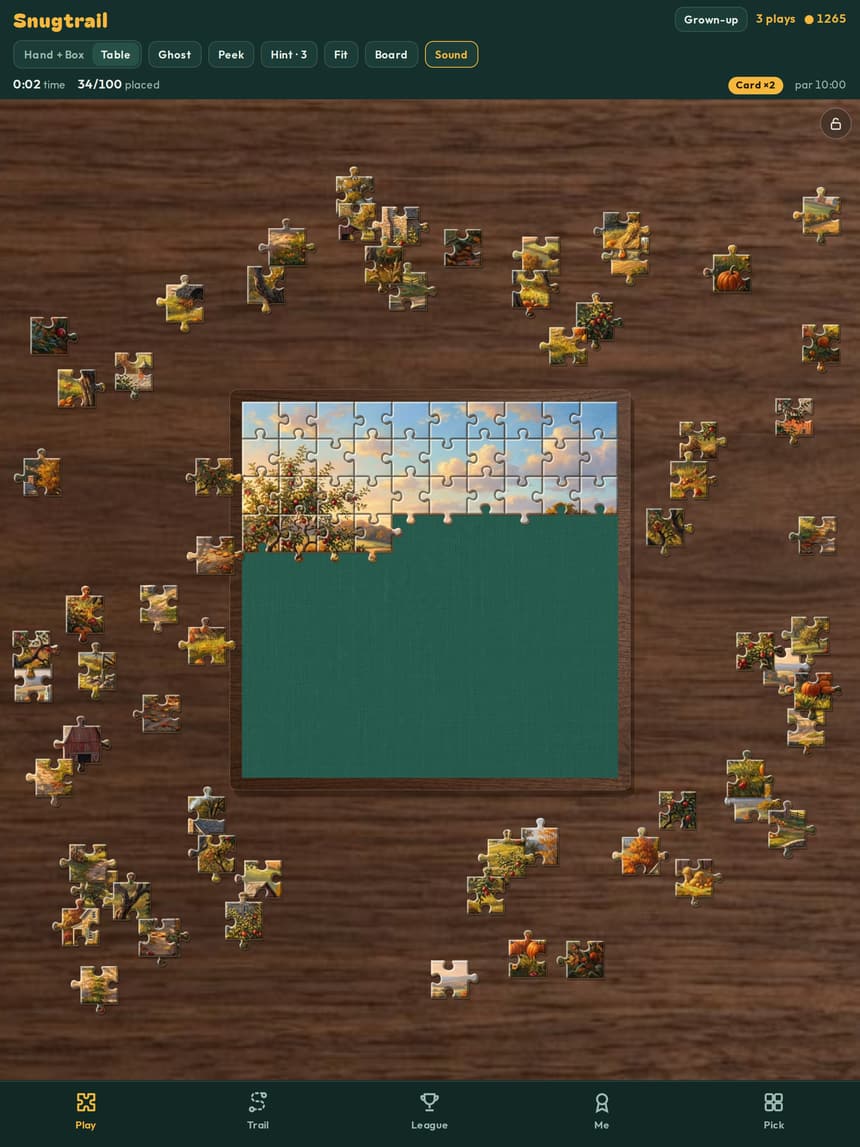 A Snugtrail puzzle on an iPad, with loose pieces spread across a walnut table